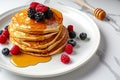 Delicious pancakes with berries, honey or maple syrup. Homemade pancakes and sweet syrup on white plate isolated. Royalty Free Stock Photo