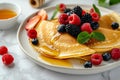 Delicious pancakes with berries, honey or maple syrup. Homemade pancakes and sweet syrup on white plate isolated. Royalty Free Stock Photo