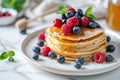 Delicious pancakes with berries, honey or maple syrup. Homemade pancakes and sweet syrup on white plate isolated. Royalty Free Stock Photo