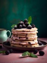 Delicious pancakes cake with fresh blackberries, cream and mint leaf on a nice dusty pink and green color background