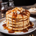 Delicious Pancakes With Caramel, Peanuts, Syrup, And Chocolate