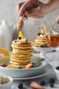 Delicious pancakes, with fresh blueberries, strawberries and honey on plate. Royalty Free Stock Photo
