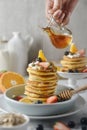 Delicious pancakes, with fresh blueberries, strawberries and honey on plate. Royalty Free Stock Photo