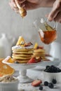 Delicious pancakes, with fresh blueberries, strawberries and honey on plate. Royalty Free Stock Photo