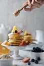 Delicious pancakes, with fresh blueberries, strawberries and honey on plate. Royalty Free Stock Photo