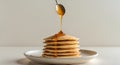 Delicious pancakes with honey dripping from a spoon on a plate Royalty Free Stock Photo