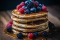 Delicious pancakes with maple syrup and fresh berries served on rustic wooden background Royalty Free Stock Photo