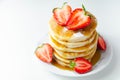 Delicious pancakes stacked with fresh sweet strawberries, topped with maple syrup Royalty Free Stock Photo