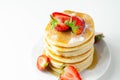 Delicious pancakes stacked with fresh sweet strawberries, topped with maple syrup Royalty Free Stock Photo