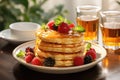 Delicious pancakes are stacked on a plate with fresh berries and poured with maple syrup. Breakfast Royalty Free Stock Photo