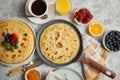Delicious pancakes on stone frying pan. Placed on table with various ingredients Royalty Free Stock Photo