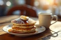 Delicious pancakes with syrup and butter on a sunny morning