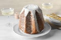 Pandoro cake decorated with powdered sugar and sparkling wine on white wooden table. Traditional Italian pastry Royalty Free Stock Photo