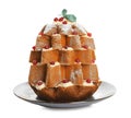 Delicious Pandoro Christmas tree cake decorated with powdered sugar and berries on white background