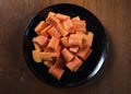 Delicious papaya on the black dish and wood background