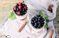 Delicious parfait dessert with bilberry, milk souffle and jello layers. Frozen treat in a glass on rustic wooden Royalty Free Stock Photo