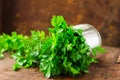 Delicious Parsley sprigs in a brown wicker basket and wooden board. Garden parsley herbs. Organic effective source of anti-oxidant Royalty Free Stock Photo