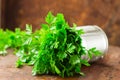 Delicious Parsley sprigs in a brown wicker basket and wooden board. Garden parsley herbs. Organic effective source of anti-oxidant Royalty Free Stock Photo