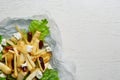 Delicious parsnip with lettuce, feta cheese and dates on white wooden table, top view. Space for text