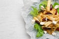 Delicious parsnip with lettuce, feta cheese and dates on white wooden table, top view. Space for text