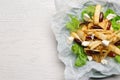 Delicious parsnip with lettuce, feta cheese and dates on white wooden table, top view. Space for text