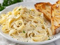 Delicious pasta dish with creamy sauce and garlic bread