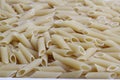 Delicious pasta, penne noodles background. Top view scene, healthy eating or healthy lifestyle. Royalty Free Stock Photo