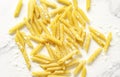 Delicious pasta, penne noodles and flour background Royalty Free Stock Photo