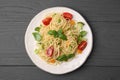 Delicious pasta primavera with tomatoes, basil and broccoli on grey table, top view Royalty Free Stock Photo