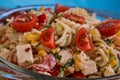 Delicious pasta salad or Mediterranean salad. Tomatoes with mozzarella basil corn spice and olive oil on a wooden table. Royalty Free Stock Photo