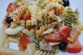 Delicious pasta salad with tomato corn asparagus egg sauce rose Royalty Free Stock Photo