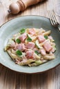 Delicious pasta with salmon pieces, sliced zucchini