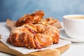 Delicious pastries and coffee on white table, closeup