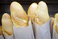 Delicious pastries french baguettes. Loaves of white bread in paper bags close-up. Royalty Free Stock Photo