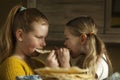 Delicious pastries. Two little girls eats flatbread lavash at home for breakfast. True childhood friendship Royalty Free Stock Photo