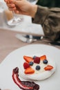 Delicious pavlova dessert on a white plate with meringues, cream and fresh fruits Royalty Free Stock Photo
