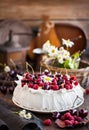 Delicious Pavlova meringue cake decorated with fresh raspberries and cherries