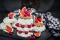 Delicious Pavlova meringue cakes decorated with chocolate cream, fresh figs and raspberries on dark background Royalty Free Stock Photo