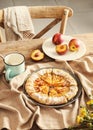 Delicious peach galette with milk on wooden table