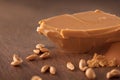 delicious peanut butter closeup photo under studio lighting, peanuts spread on the table