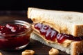 Delicious peanut butter and jelly sandwich on toast bread cut in half. Popular American snack