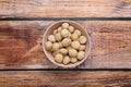 Delicious peeled Macadamia nuts in bowl on wooden table, top view Royalty Free Stock Photo