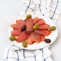 Delicious peppered roast beef pastrami slices on white table Royalty Free Stock Photo