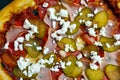 Delicious Pepperoni Pizza with Ham, Pickles, and Feta Cheese Top View