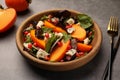 Delicious persimmon salad with cheese and pomegranate served on grey table Royalty Free Stock Photo