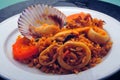 Delicious Peruvian dish of seafood rice. Cangrejo, guisantes, perejil, Prawns, scallops, mussels, clams, squid, red onion, and Royalty Free Stock Photo