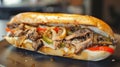 Delicious Philly cheesesteak with chopped beef peppers, caramelized onions with pickles and provolone cheese in a crisp hoagie