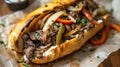 Delicious Philly cheesesteak with chopped beef peppers, caramelized onions with pickles and provolone cheese in a crisp hoagieroll