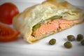 Delicious Phyllo Wrapped Salmon with Capers and Tomatoes on White Plate