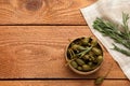 Delicious pickled capers and rosemary twigs on wooden table, flat lay. Space for text Royalty Free Stock Photo